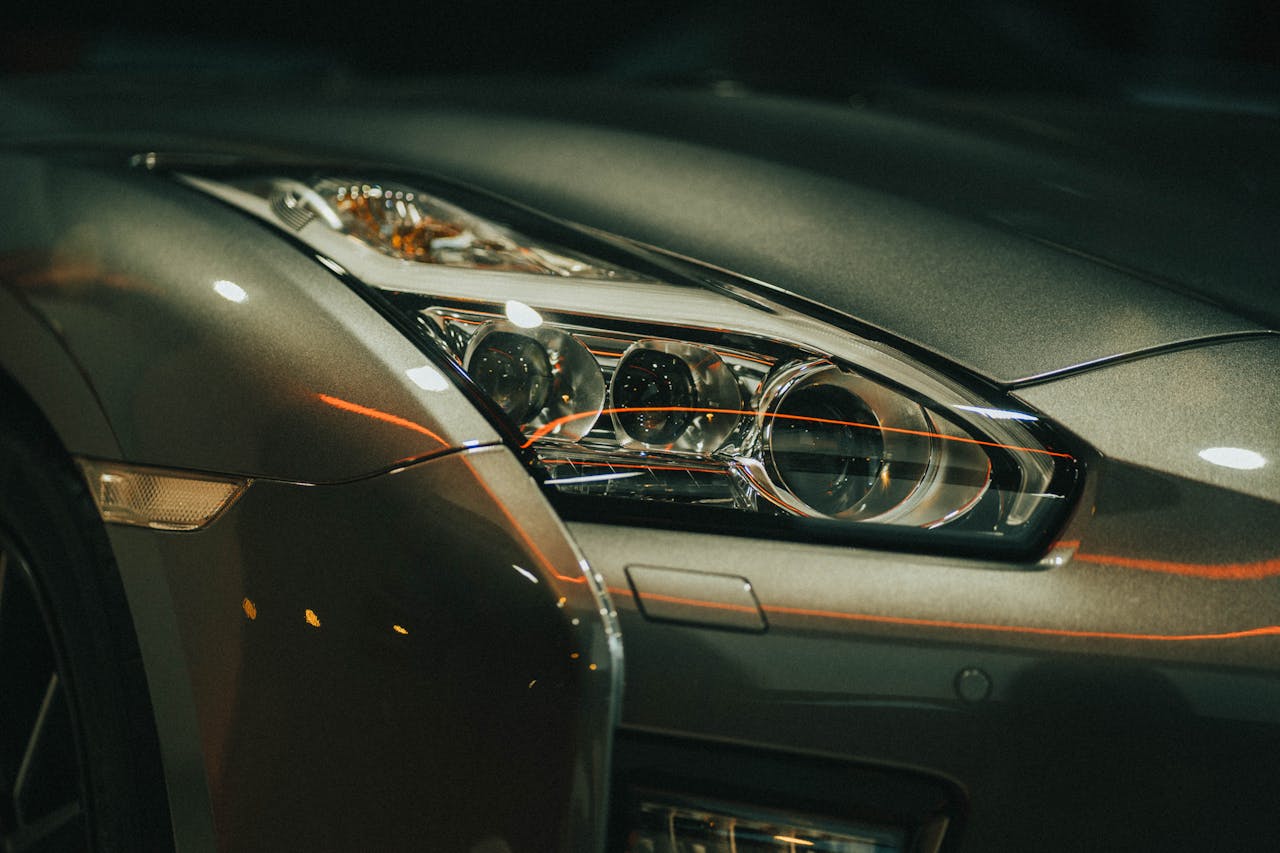 Elegant close-up of a luxury sports car headlight highlighting modern design and architecture.