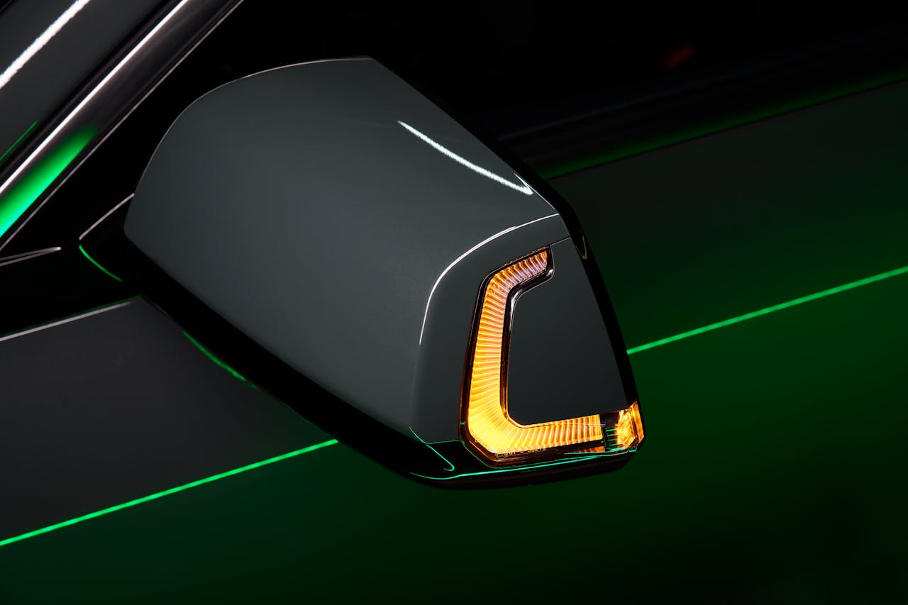 High-quality image of a car side mirror featuring a sleek design and illuminated LED indicator.