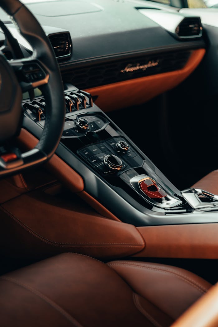 Explore the luxurious design of this car interior featuring elegant leather and modern controls.