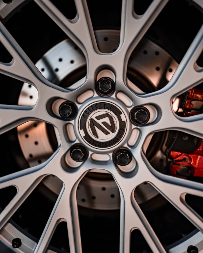 Detailed view of a luxury car alloy wheel rim with chrome finish showing elegant design and craftsmanship.